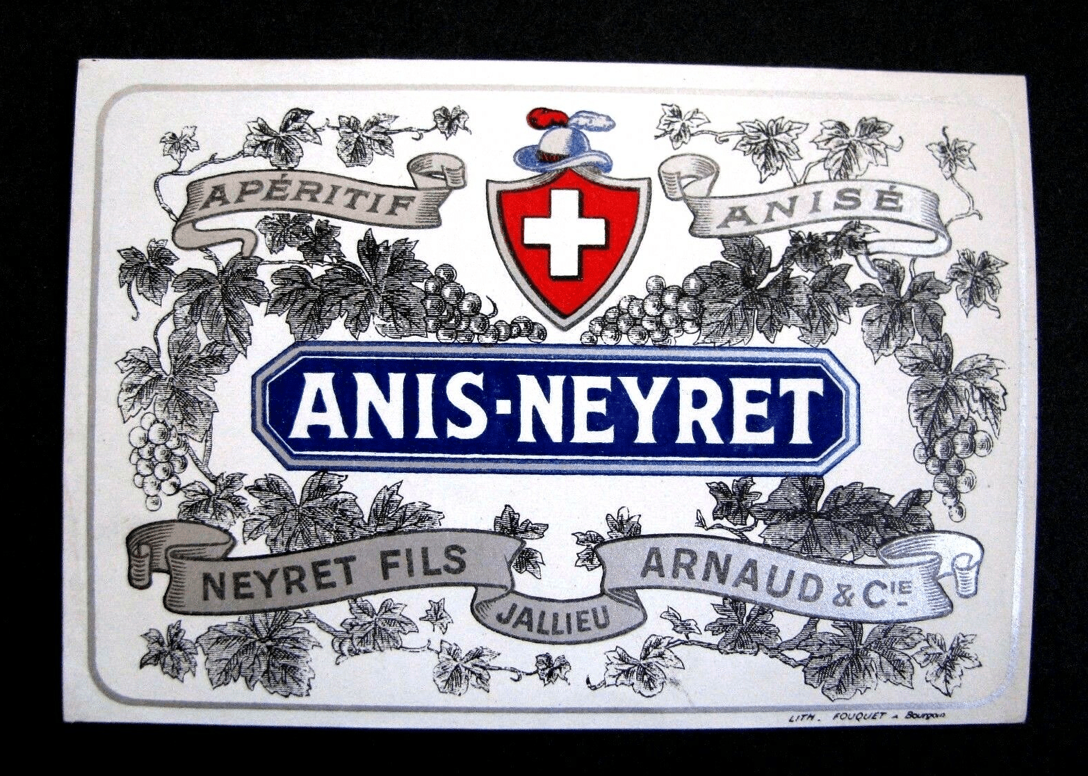 Étiquette « Apéritif anisé Anis-Neyret, Neyret fils, Arnaud & Cie, Jallieu », imprimée par la lithographie Fouquet à Bourgoin (annonce eBay archivée).