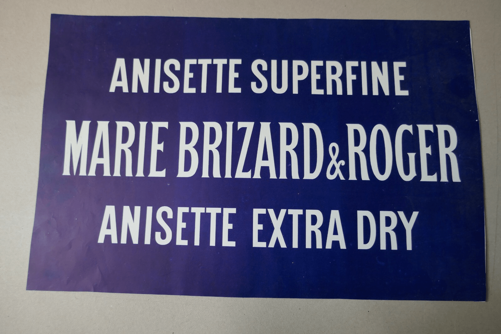 Carton publicitaire « Anisette superfine / Anisette extra dry » (annonce eBay archivée).