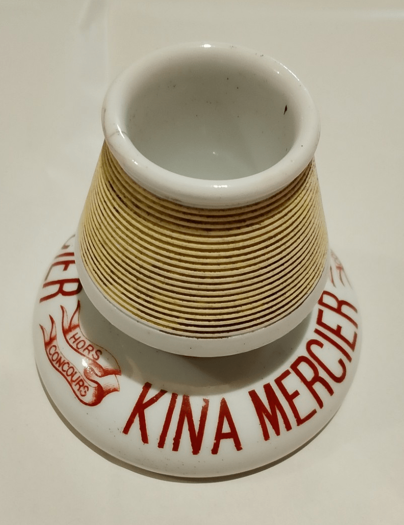 Pyrogène publicitaire en porcelaine « Kina Mercier » (annonce eBay archivée).